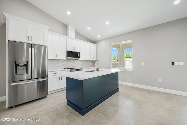 1107 Conquistador Dr, Rockledge, FL 32955 - kitchen featuring stainless steel appliances, tasteful backsplash, an island with sink, white cabinets, and lofted ceiling