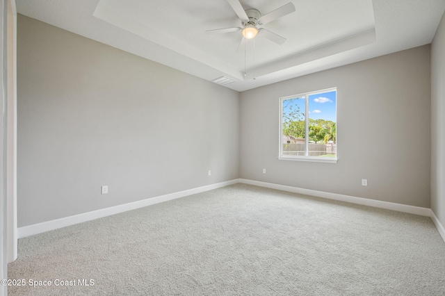 1107 Conquistador Dr, Rockledge, FL 32955 - spare room featuring a raised ceiling, a ceiling fan, and carpet floors