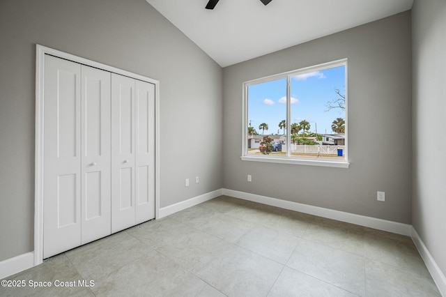 1107 Conquistador Dr, Rockledge, FL 32955 - unfurnished bedroom featuring lofted ceiling, a closet, light tile patterned flooring, and ceiling fan