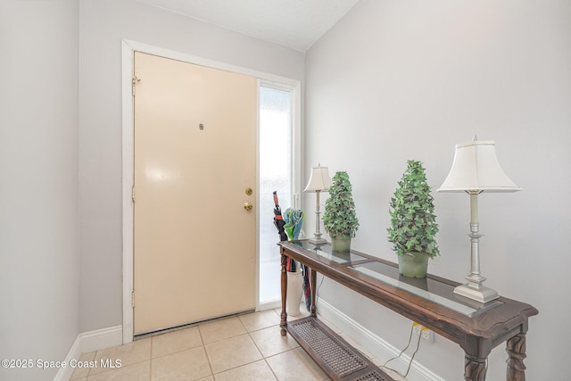 1005 Knox Mcrae Dr Unit B-210, Titusville, FL 32780 - entrance foyer featuring light tile patterned flooring and baseboards