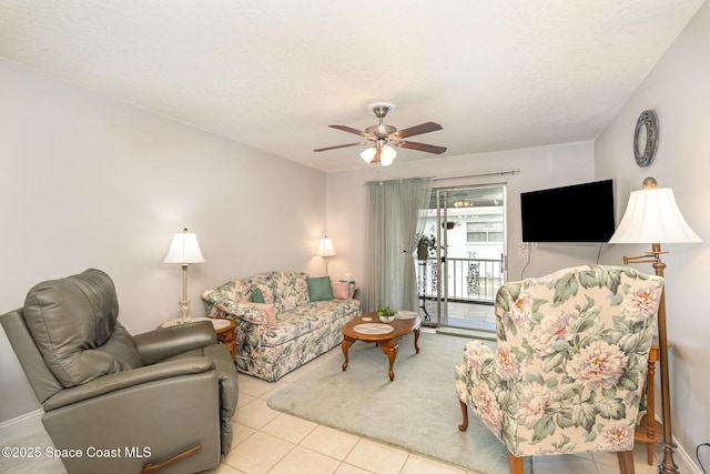 1005 Knox Mcrae Dr Unit B-210, Titusville, FL 32780 - tiled living area with ceiling fan and a textured ceiling