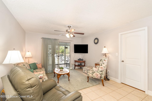 1005 Knox Mcrae Dr Unit B-210, Titusville, FL 32780 - living area with ceiling fan, a textured ceiling, and light tile patterned floors
