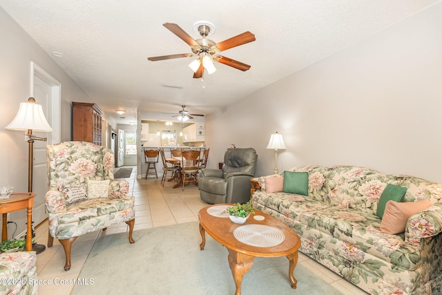 1005 Knox Mcrae Dr Unit B-210, Titusville, FL 32780 - living area with light tile patterned floors and ceiling fan