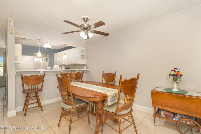 1005 Knox Mcrae Dr Unit B-210, Titusville, FL 32780 - dining room featuring a ceiling fan, light tile patterned floors, and a textured ceiling