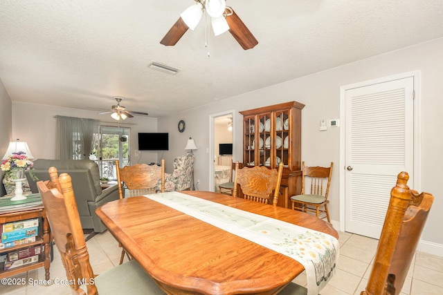 1005 Knox Mcrae Dr Unit B-210, Titusville, FL 32780 - dining room with ceiling fan, light tile patterned floors, and a textured ceiling