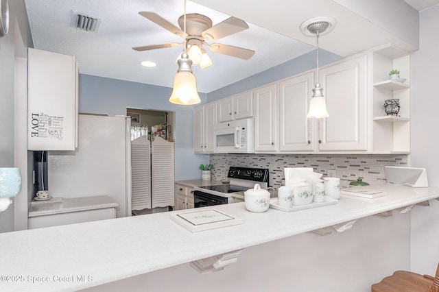1005 Knox Mcrae Dr Unit B-210, Titusville, FL 32780 - kitchen featuring white appliances, tasteful backsplash, and light countertops