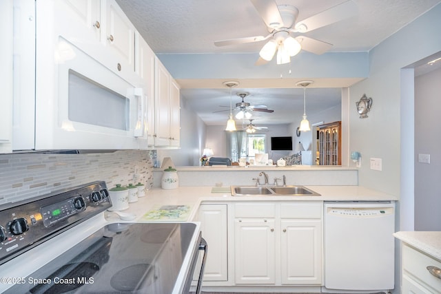 1005 Knox Mcrae Dr Unit B-210, Titusville, FL 32780 - kitchen with white appliances, ceiling fan, backsplash, and white cabinetry