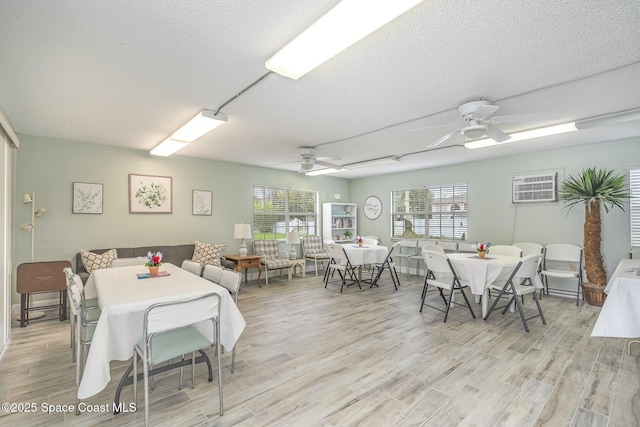 1005 Knox Mcrae Dr Unit B-210, Titusville, FL 32780 - dining area featuring ceiling fan, light wood-type flooring, and a textured ceiling