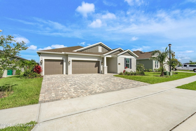 9374 Corvo Ct, Melbourne, FL 32940 - view of front of house featuring a garage, driveway, a front yard, and stucco siding