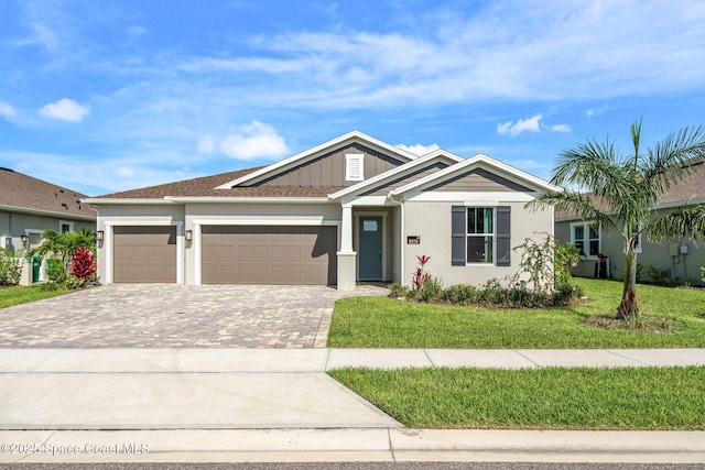 9374 Corvo Ct, Melbourne, FL 32940 - single story home featuring decorative driveway, a garage, a front yard, and stucco siding