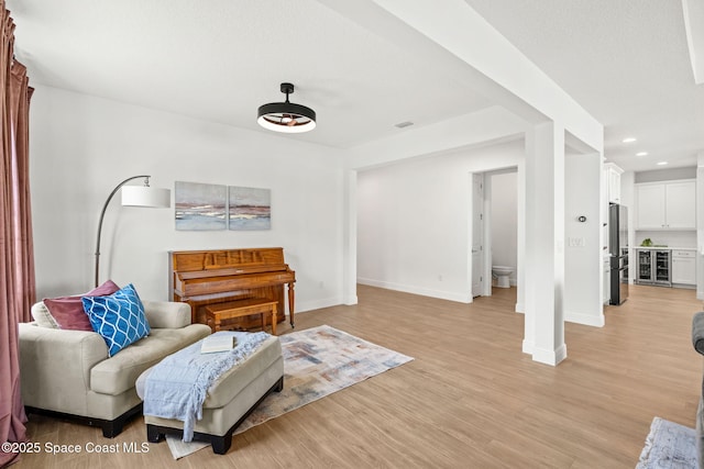 9374 Corvo Ct, Melbourne, FL 32940 - living area featuring wine cooler, light wood-style flooring, and recessed lighting