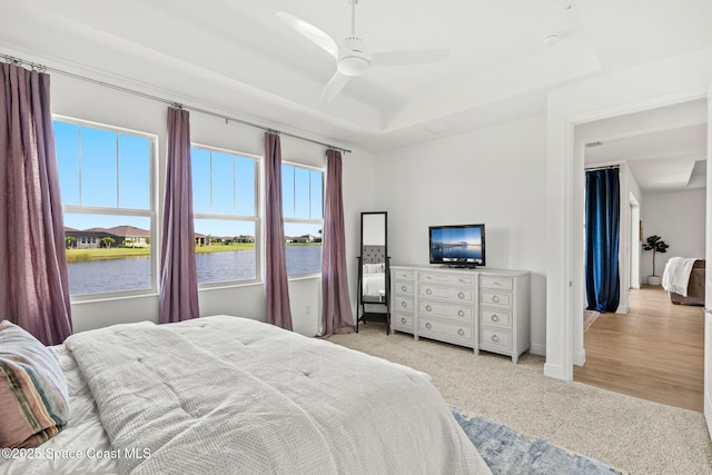 9374 Corvo Ct, Melbourne, FL 32940 - bedroom featuring light carpet, a tray ceiling, and ceiling fan