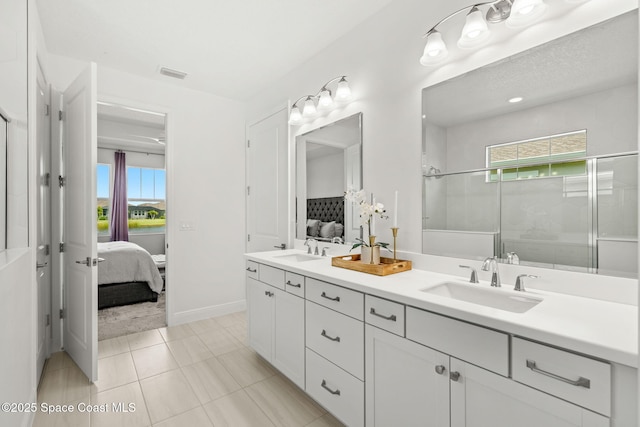 9374 Corvo Ct, Melbourne, FL 32940 - bathroom with ensuite bathroom, double vanity, a shower stall, and tile patterned flooring