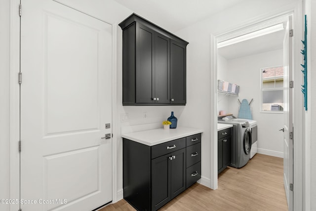 9374 Corvo Ct, Melbourne, FL 32940 - washroom featuring washing machine and dryer, cabinet space, and light wood-style floors