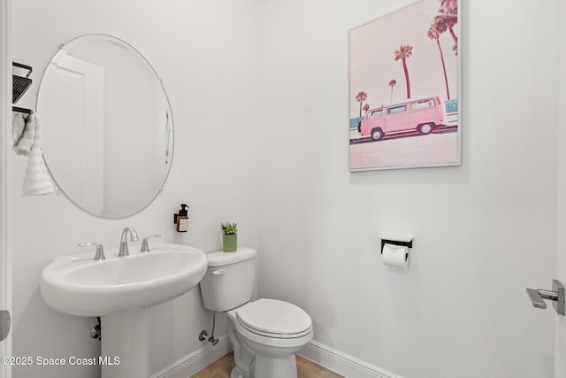 9374 Corvo Ct, Melbourne, FL 32940 - half bath featuring toilet and wood finished floors