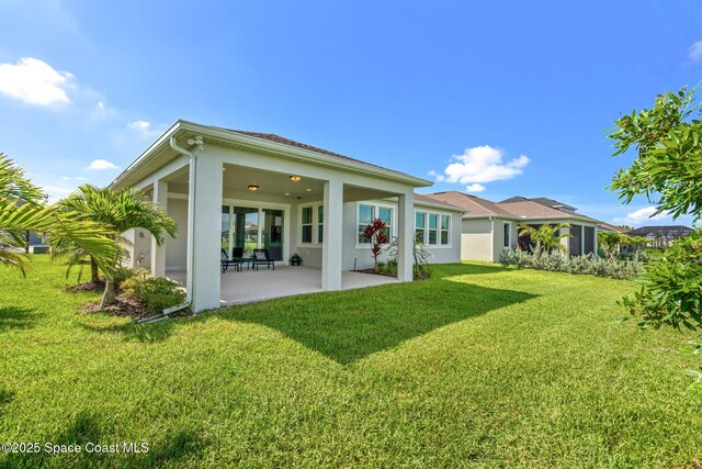 9374 Corvo Ct, Melbourne, FL 32940 - rear view of property featuring a patio area, stucco siding, and a yard