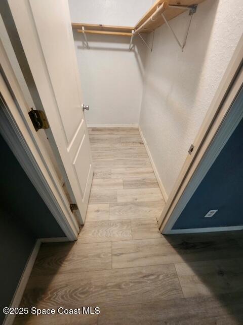 2101 Forest Knoll Dr NE Unit 01-101, Palm Bay, FL 32905 - spacious closet with wood finished floors