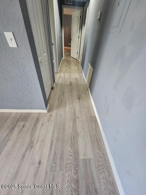 2101 Forest Knoll Dr NE Unit 01-101, Palm Bay, FL 32905 - hallway with light wood-style floors and baseboards