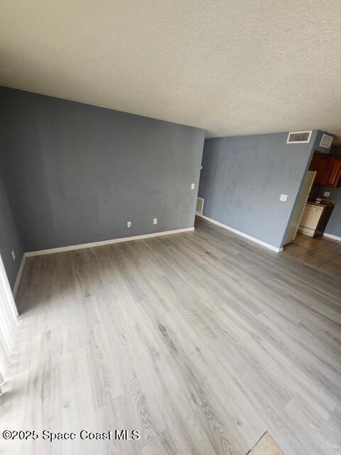 2101 Forest Knoll Dr NE Unit 01-101, Palm Bay, FL 32905 - unfurnished room with wood finished floors and a textured ceiling