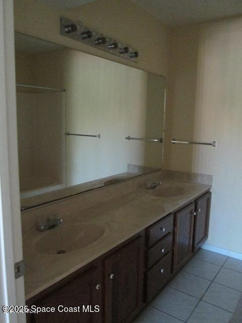 2101 Forest Knoll Dr NE Unit 01-101, Palm Bay, FL 32905 - bathroom with double vanity and tile patterned floors