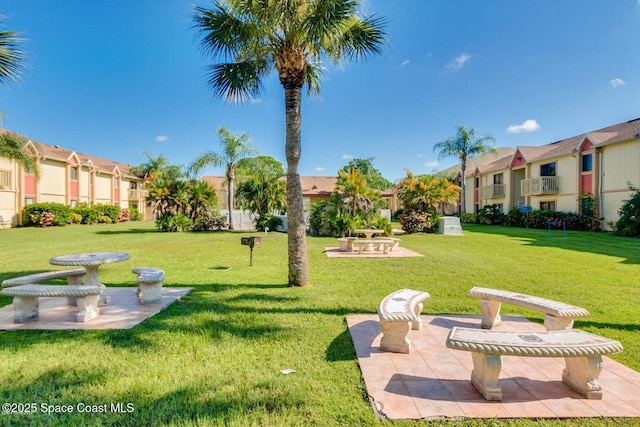 2101 Forest Knoll Dr NE Unit 01-101, Palm Bay, FL 32905 - surrounding community with a residential view and a lawn