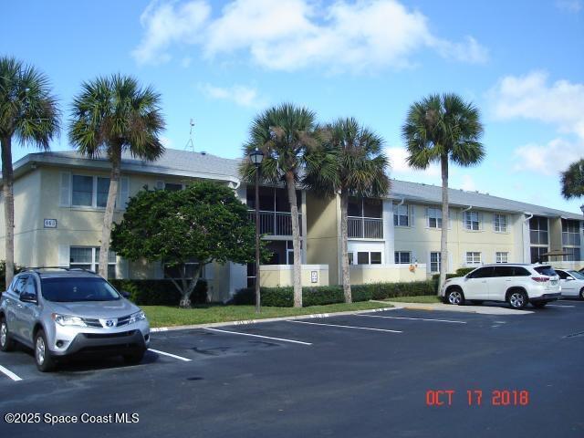 945 Sonesta Ave NE Unit 103, Palm Bay, FL 32905 - view of building exterior with uncovered parking