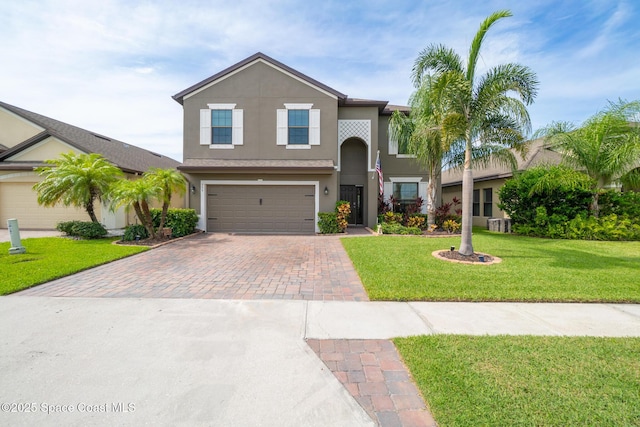 739 Fiddleleaf Cir, Melbourne, FL 32904 - traditional-style home with decorative driveway, a garage, stucco siding, and a front yard