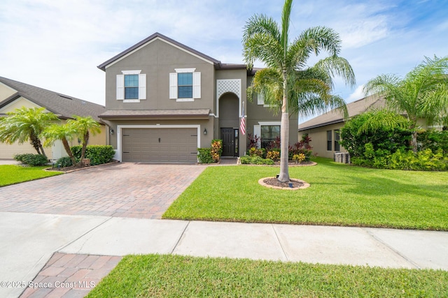 739 Fiddleleaf Cir, Melbourne, FL 32904 - traditional home featuring decorative driveway, stucco siding, a garage, and a front lawn