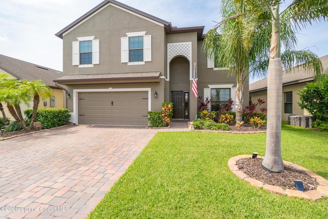 739 Fiddleleaf Cir, Melbourne, FL 32904 - traditional-style home featuring a garage, decorative driveway, stucco siding, and a front lawn