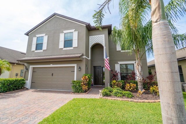739 Fiddleleaf Cir, Melbourne, FL 32904 - traditional-style house featuring stucco siding, a garage, decorative driveway, and a front lawn