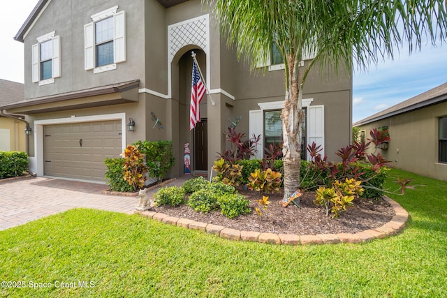 739 Fiddleleaf Cir, Melbourne, FL 32904 - view of front of house featuring stucco siding, decorative driveway, a front yard, and a garage