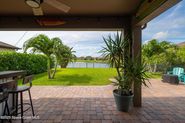 739 Fiddleleaf Cir, Melbourne, FL 32904 - fenced backyard featuring a water view, ceiling fan, and a patio