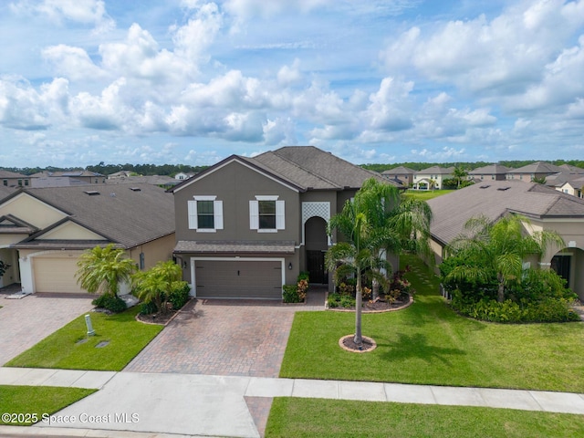 739 Fiddleleaf Cir, Melbourne, FL 32904 - traditional-style home featuring stucco siding, a residential view, decorative driveway, a garage, and a front yard