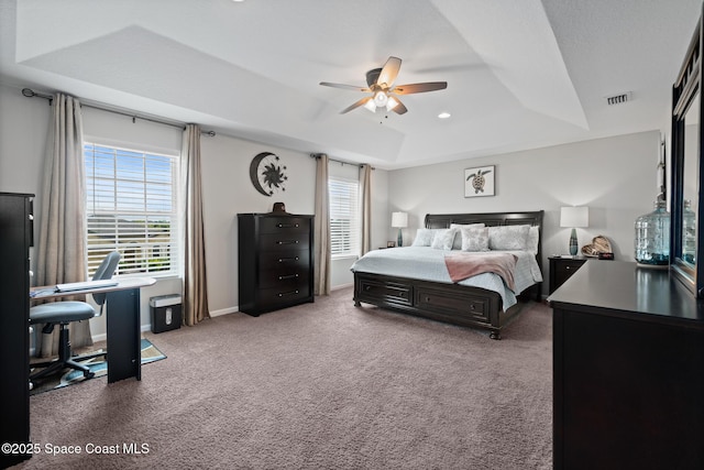 739 Fiddleleaf Cir, Melbourne, FL 32904 - carpeted bedroom featuring a tray ceiling, multiple windows, a desk, and ceiling fan