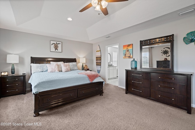 739 Fiddleleaf Cir, Melbourne, FL 32904 - bedroom with light carpet, a tray ceiling, ensuite bath, and ceiling fan
