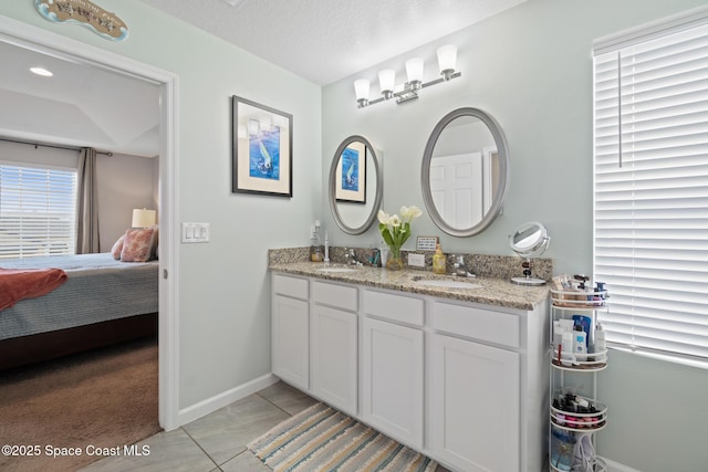 739 Fiddleleaf Cir, Melbourne, FL 32904 - ensuite bathroom featuring double vanity and baseboards