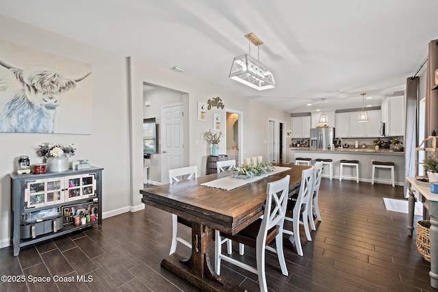739 Fiddleleaf Cir, Melbourne, FL 32904 - dining room featuring dark wood-style floors and baseboards