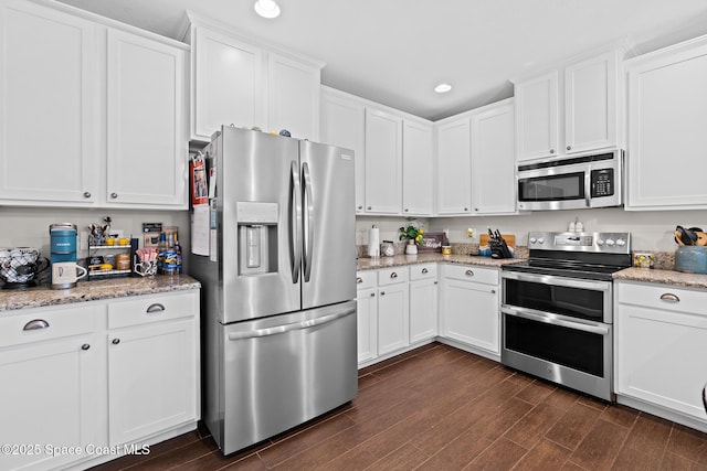 739 Fiddleleaf Cir, Melbourne, FL 32904 - kitchen featuring stainless steel appliances, dark wood-type flooring, white cabinets, recessed lighting, and light stone counters