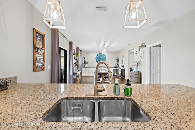 739 Fiddleleaf Cir, Melbourne, FL 32904 - kitchen with a sink and light stone countertops