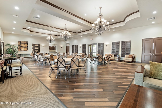739 Fiddleleaf Cir, Melbourne, FL 32904 - dining room featuring a chandelier, a raised ceiling, crown molding, wood finished floors, and recessed lighting