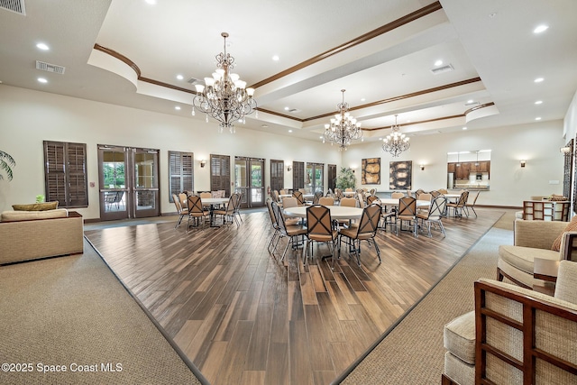 739 Fiddleleaf Cir, Melbourne, FL 32904 - dining space featuring a raised ceiling, a chandelier, wood finished floors, recessed lighting, and ornamental molding
