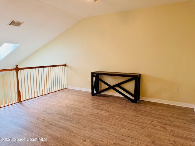 524 Mcguire Blvd, Indian Harbour Beach, FL 32937 - additional living space with a skylight, wood finished floors, and lofted ceiling