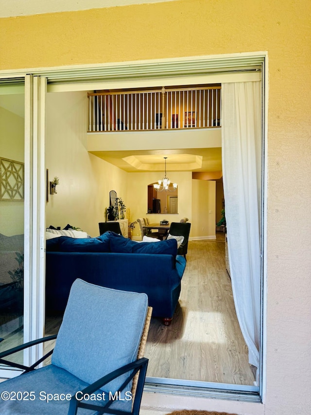 524 Mcguire Blvd, Indian Harbour Beach, FL 32937 - living room featuring wood finished floors and a chandelier