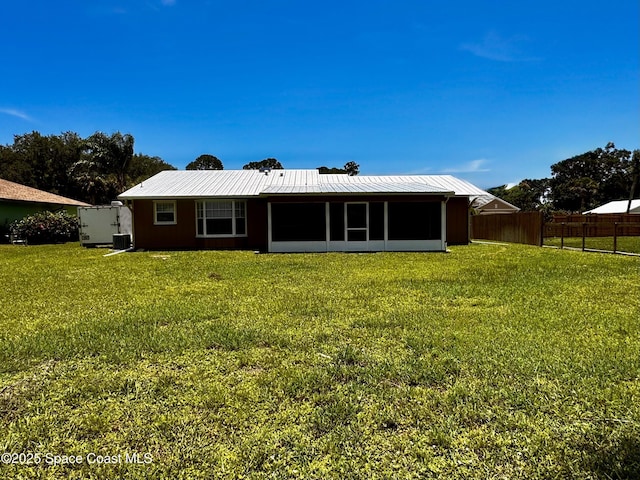 658 Ervin St, Sebastian, FL 32958 - back of property featuring a metal roof and a sunroom