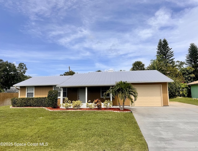 658 Ervin St, Sebastian, FL 32958 - ranch-style home featuring concrete driveway, a garage, and a metal roof
