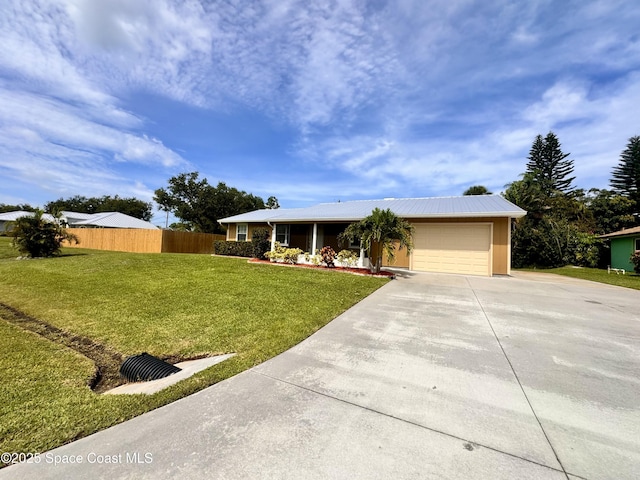 658 Ervin St, Sebastian, FL 32958 - ranch-style home featuring driveway, a garage, and a metal roof