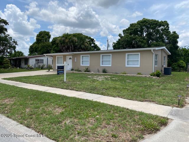 3037 Rowe St NE, Palm Bay, FL 32905 - single story home with a front lawn, stucco siding, and concrete driveway