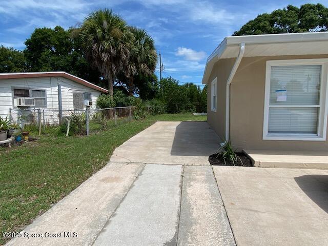 3037 Rowe St NE, Palm Bay, FL 32905 - view of yard featuring a patio area and cooling unit