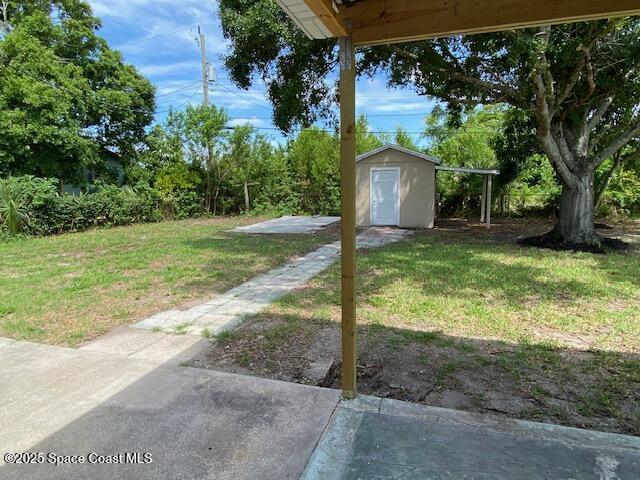 3037 Rowe St NE, Palm Bay, FL 32905 - view of green lawn with a shed