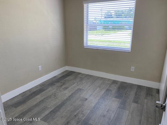 3037 Rowe St NE, Palm Bay, FL 32905 - empty room featuring dark wood-type flooring and baseboards